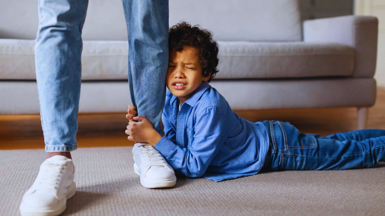 A child and his mother are playing together on the floor, sharing a joyful moment of interaction and fun.