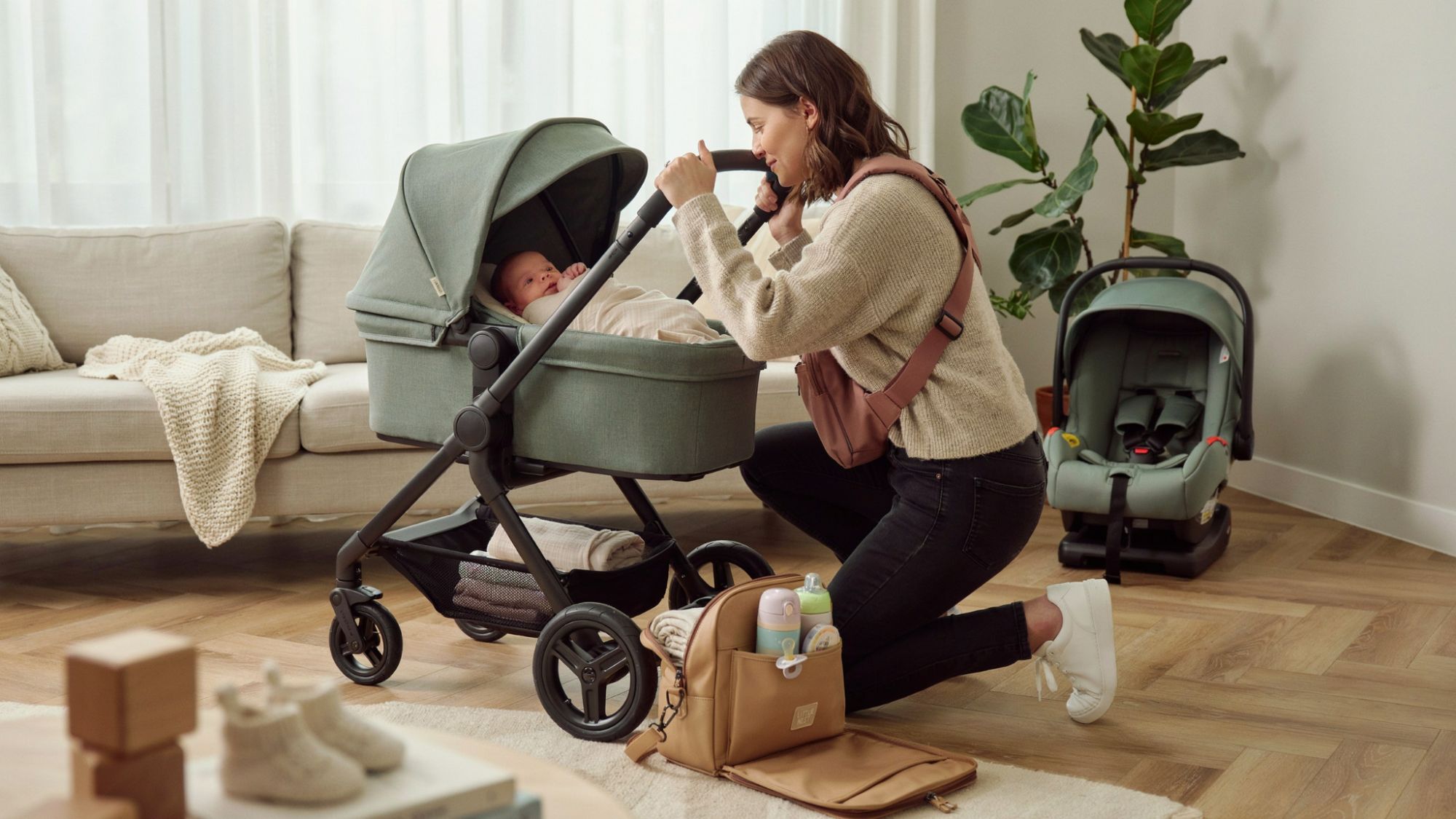 Baby travel essentials including stroller, carrier, car seat, and diaper bag.