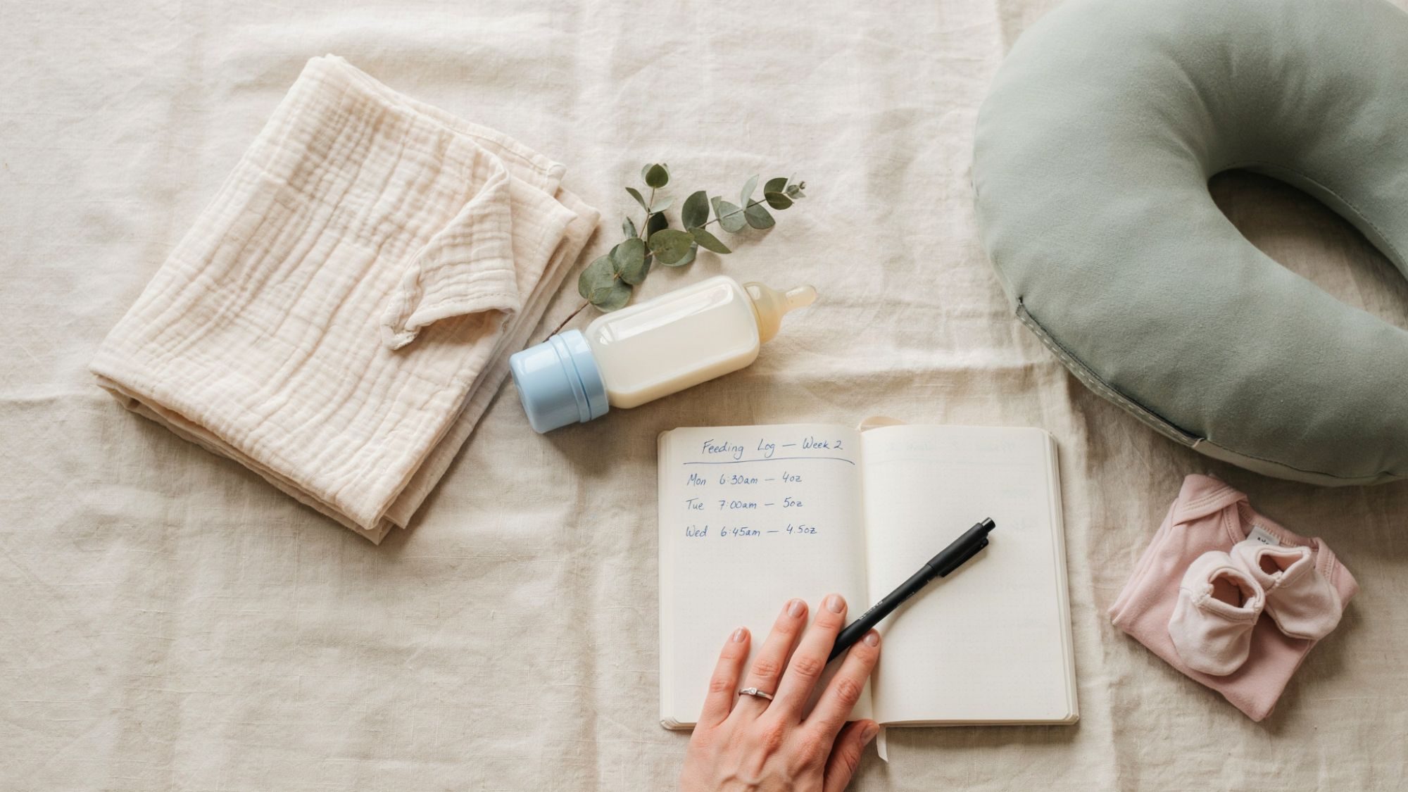 Newborn feeding routine essentials arranged with notes and baby care items.