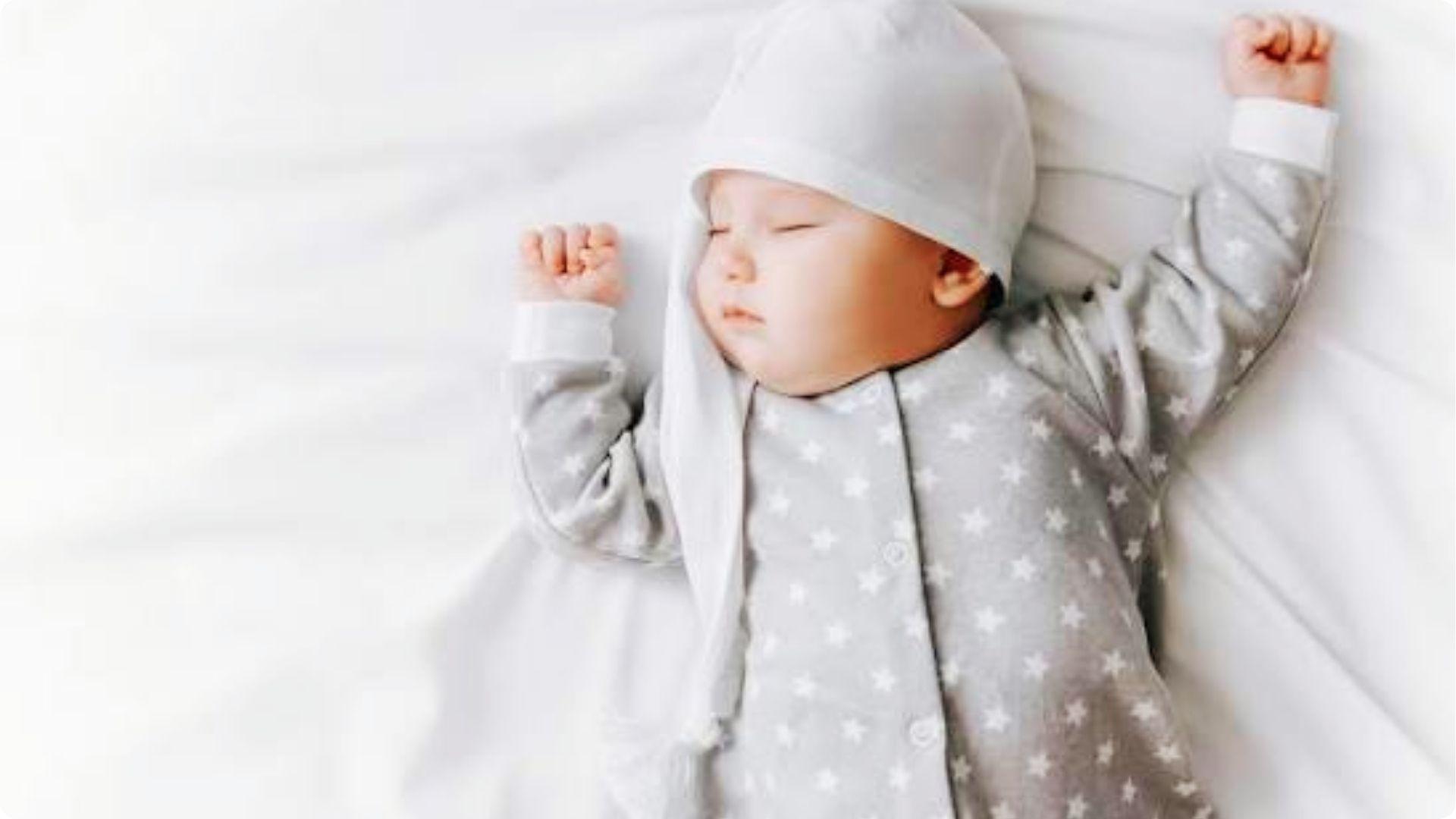 Peaceful newborn in star suit sleeping soundly during early stage of baby sleep regression phase