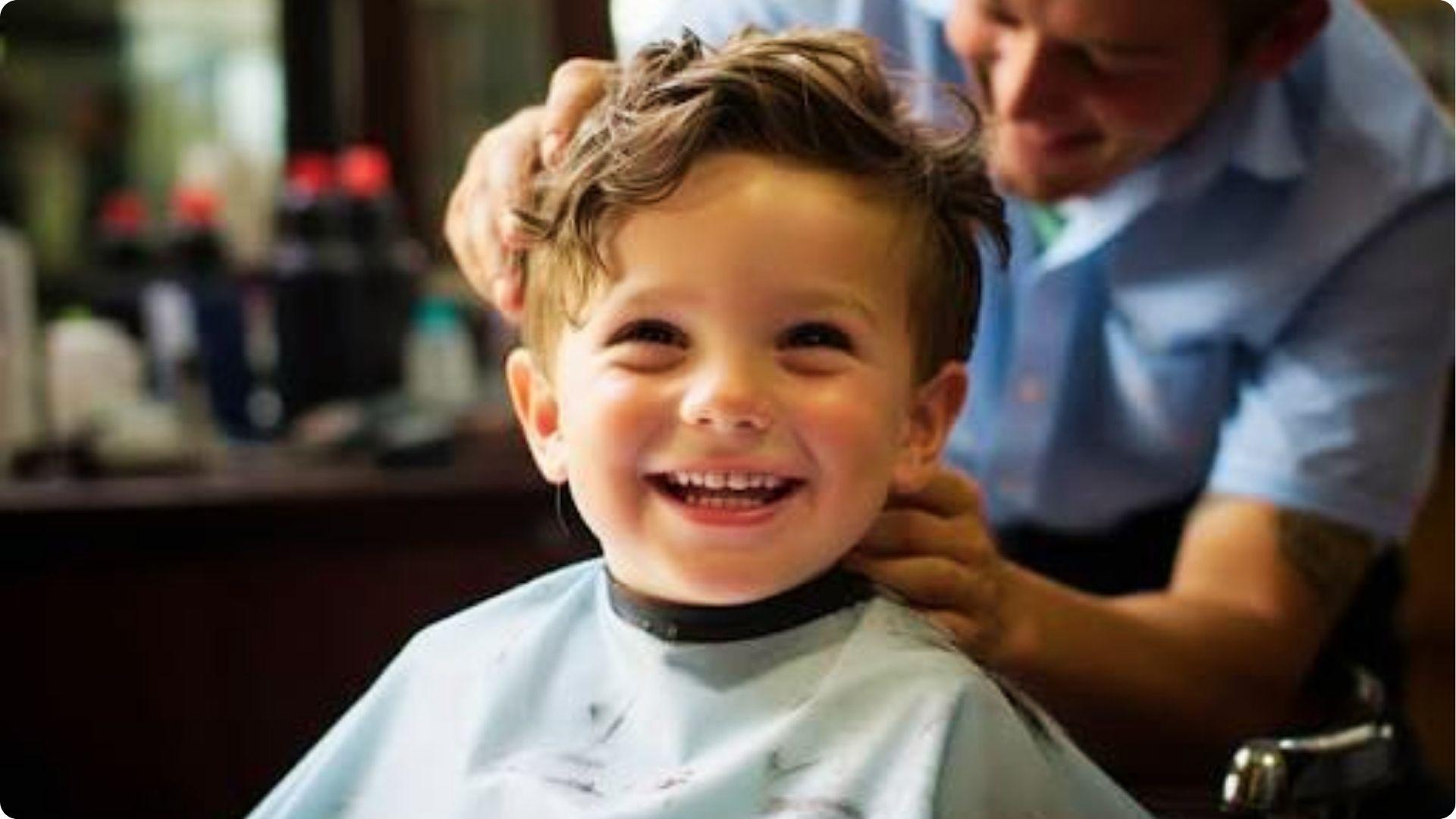 Toddler with slick side-part comb-over and shaved hard line, low skin fade, formal stylish haircut.