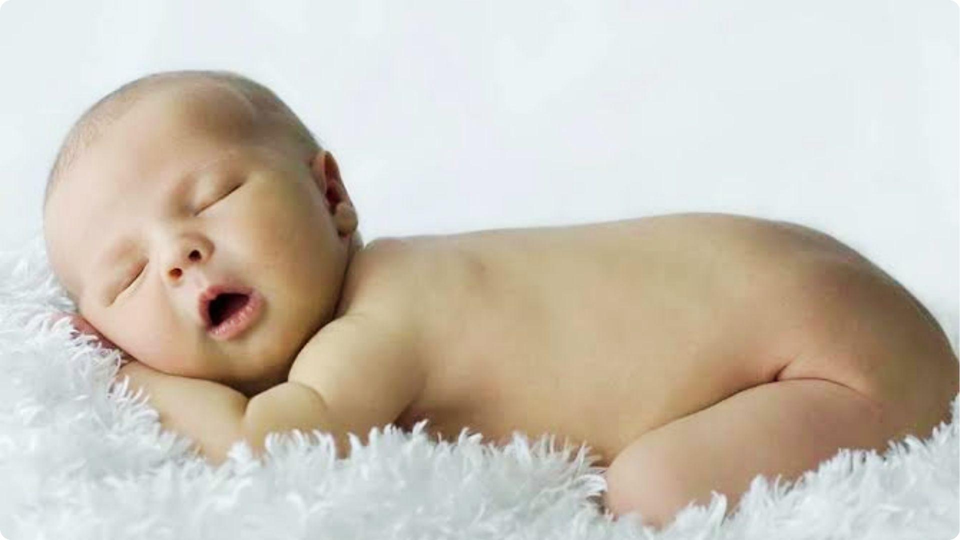 Newborn sleeps on soft white rug mouth open, early reflex showing can babies breathe through mouth