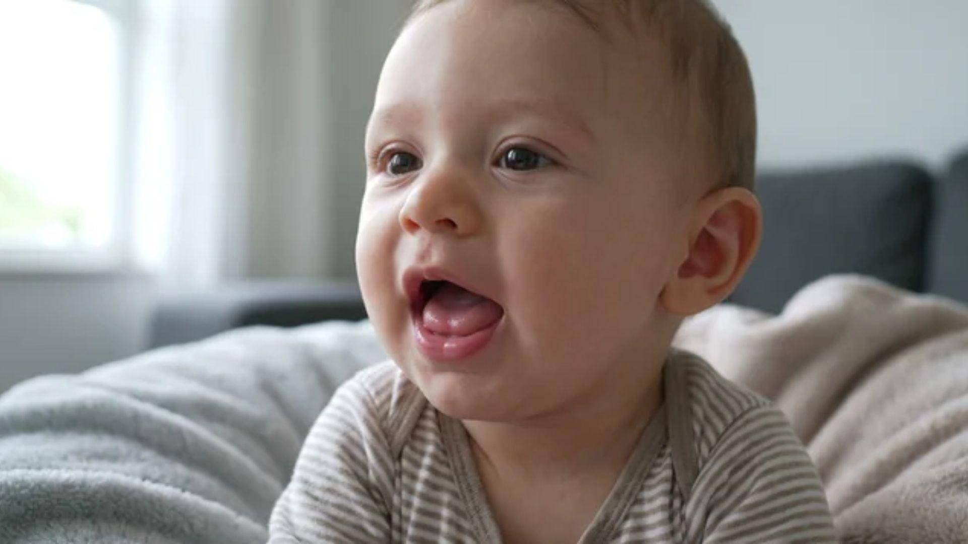 Six-month-old infant with an open mouth during babbling