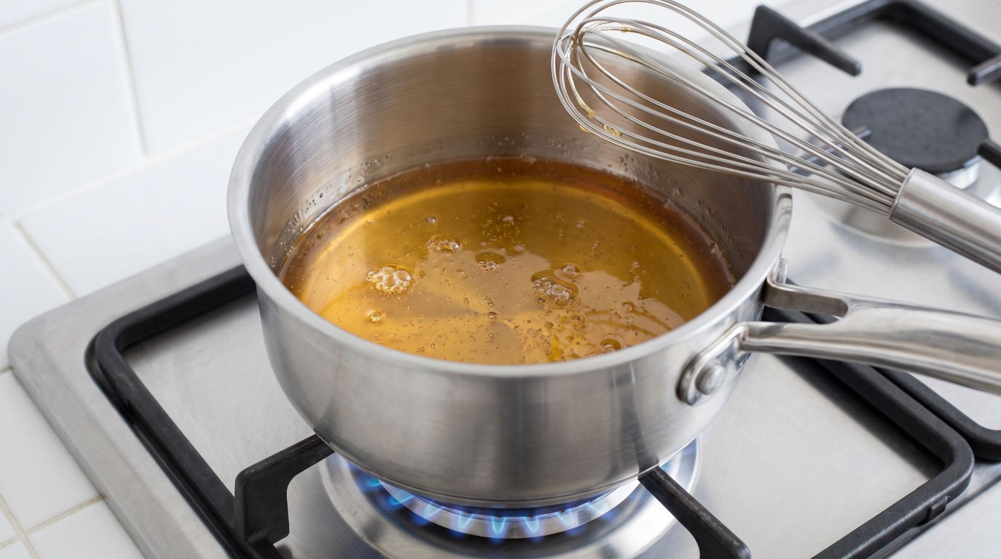  Honey heating in a saucepan on a kitchen stovetop
