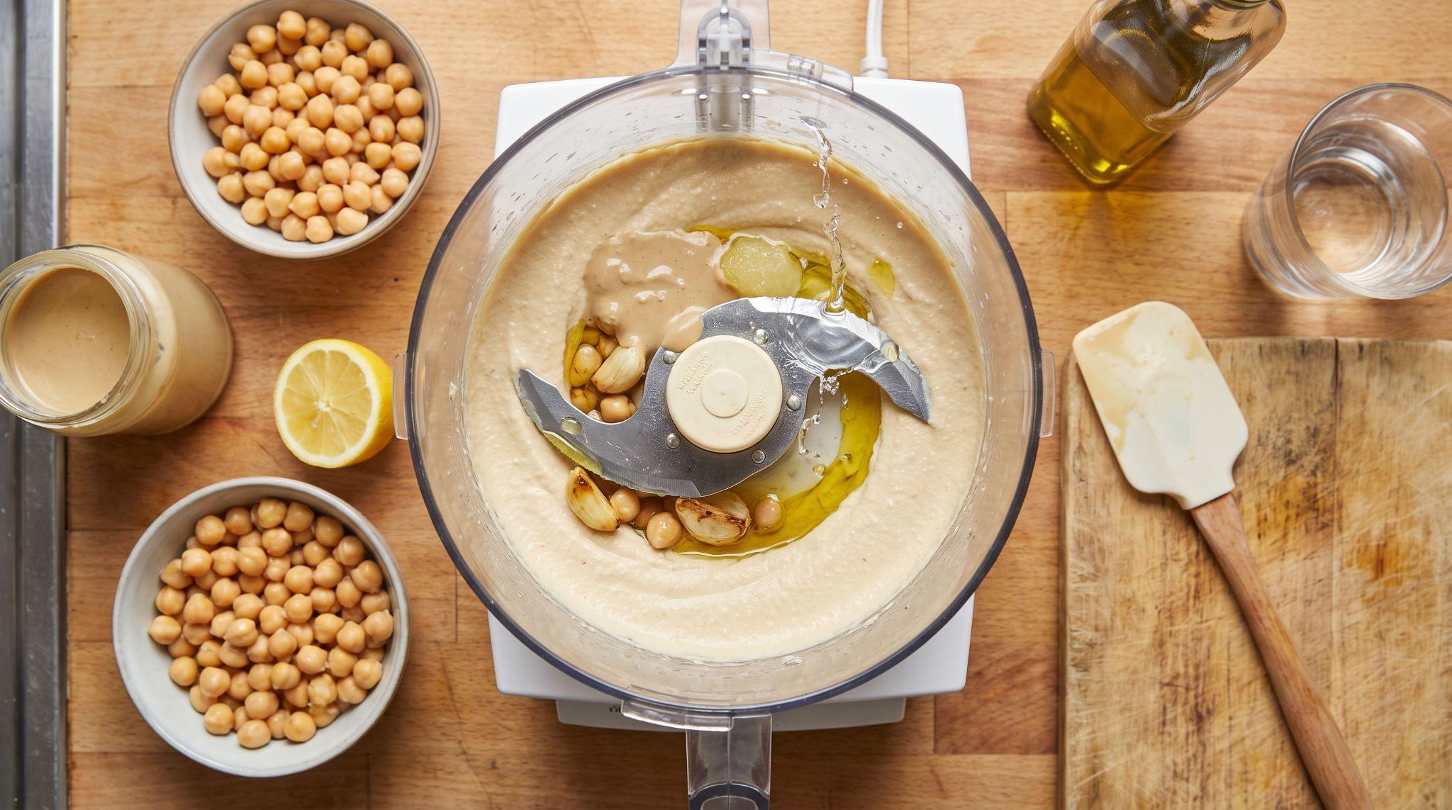 Chickpeas and hummus ingredients blending in a food processor