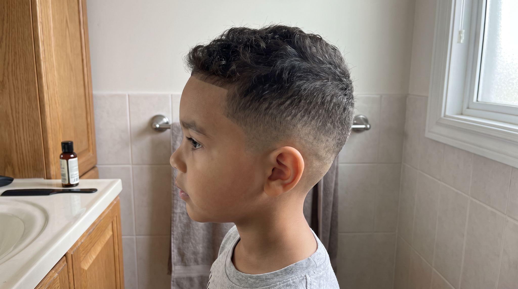 Low fade with maintained sides and wavy hair on top