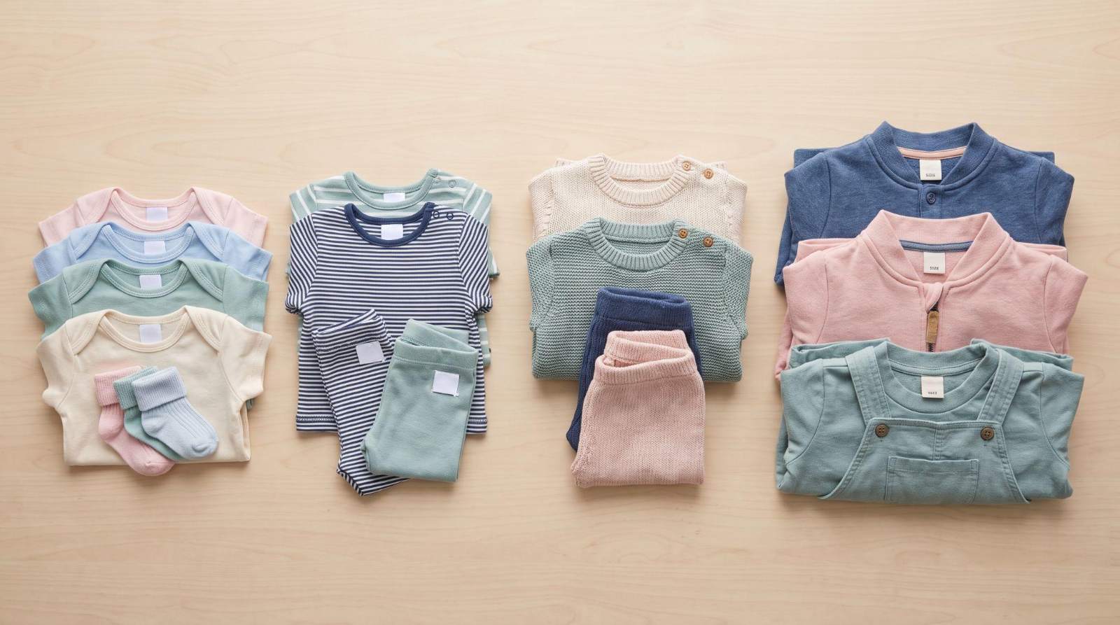Folded baby clothes arranged in different sizing groups