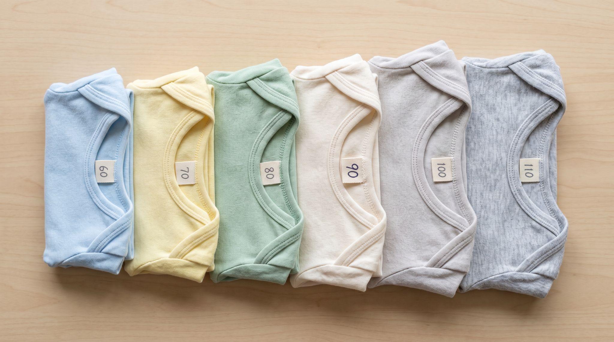 Baby and toddler garments arranged from smaller to larger sizes