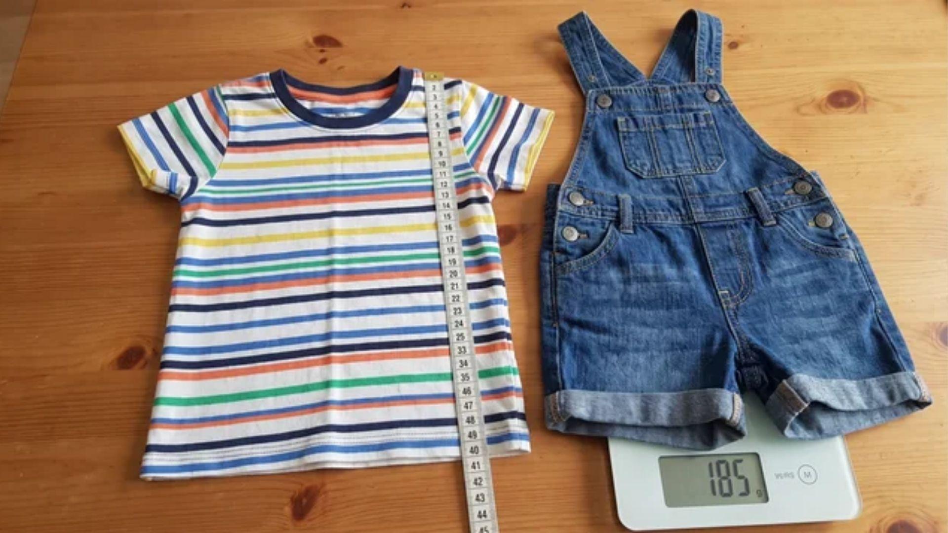 Toddler clothes beside a measuring tape and weighing scale