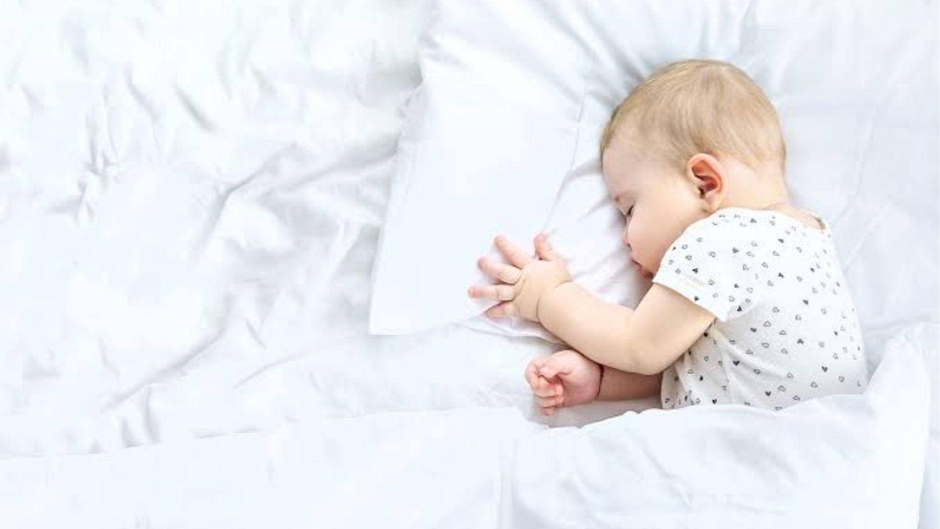 Sleepy baby resting in a parent’s arms during the day after a restless night