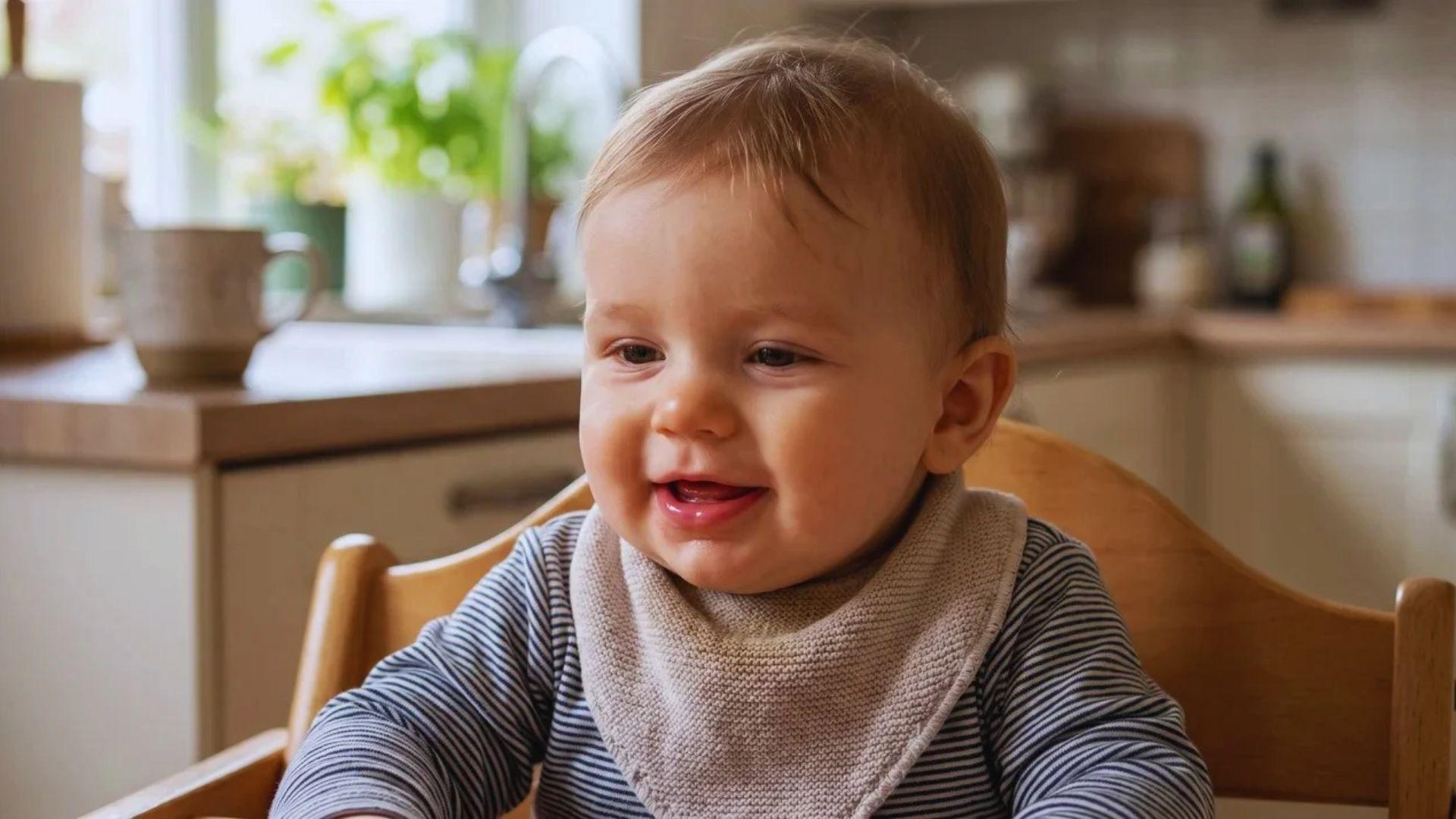 Baby with slightly swollen lower gums visible inside the open mouth.