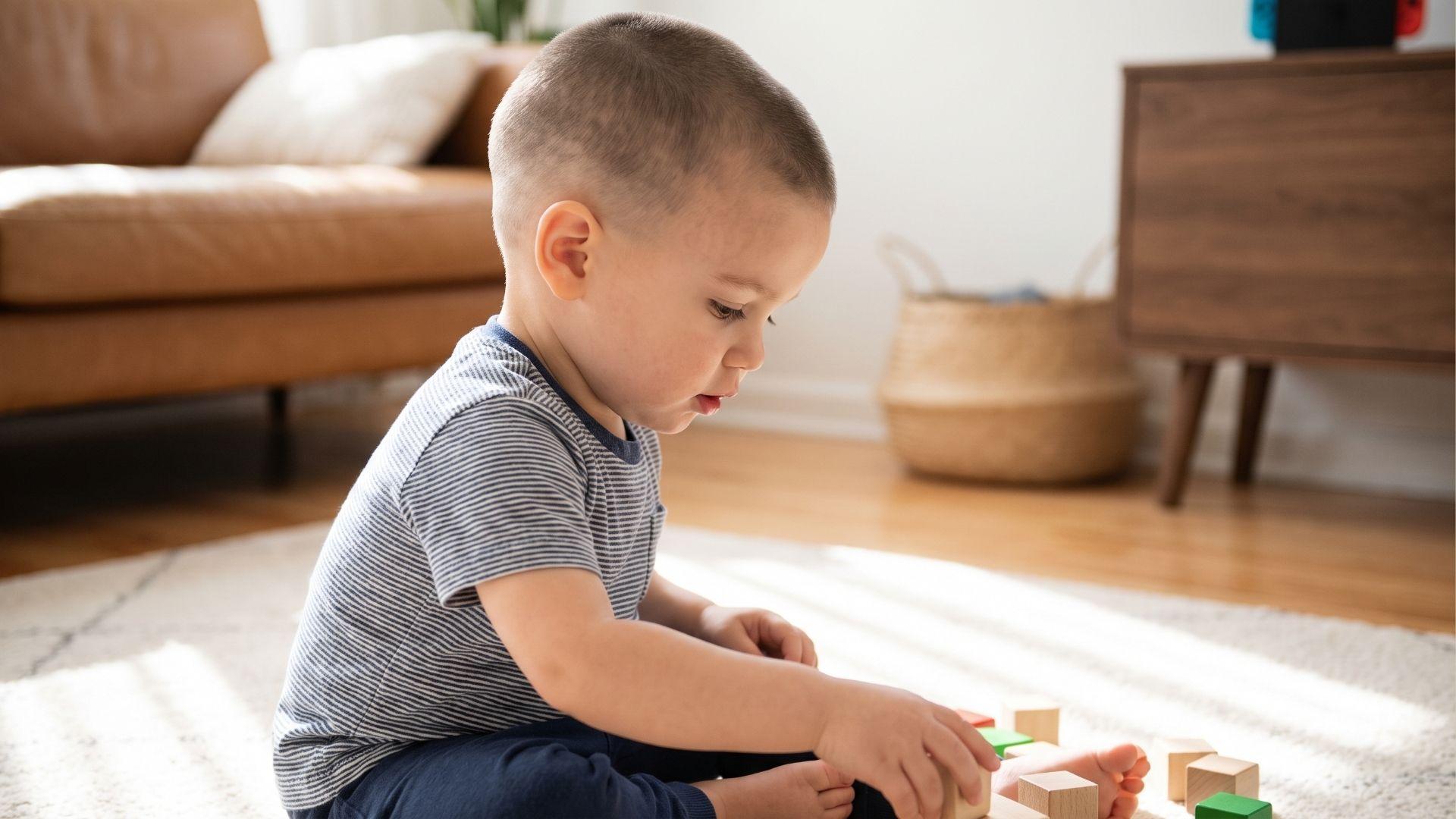 Toddler boy with a short buzz cut blended into a soft low fade around the sides and back