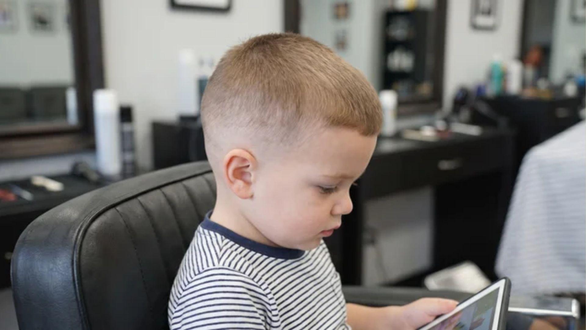 Toddler boy with a short crew cut and neatly blended low fade on the sides