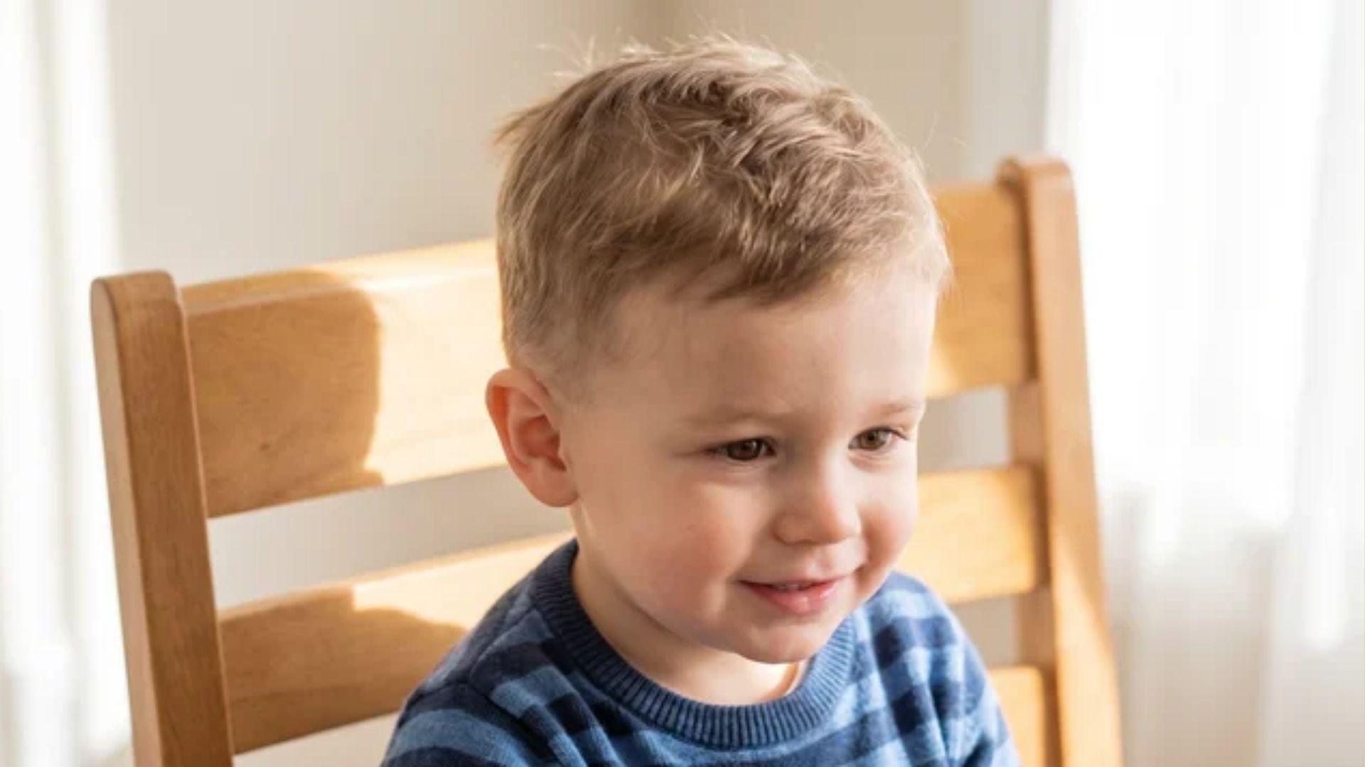 Toddler boy with fine hair styled in a short textured top and soft low fade haircut