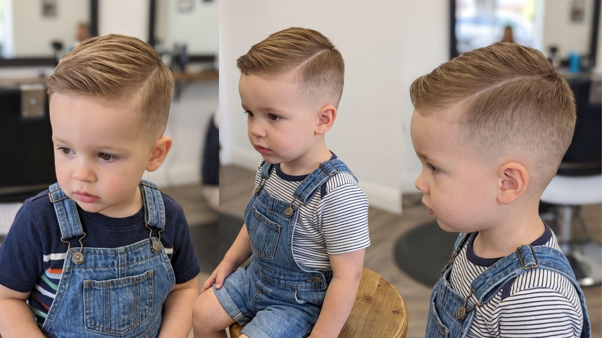 Toddler boy with a short side-swept top and clean mid fade haircut